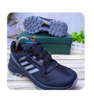 Rugged grey hiking shoes with black and orange accents Features the Adidas logo on the tongue and side "TERREX" branding printed on the side Durable Continental rubber sole for enhanced grip Comfortable fit for sizes 40 to 45 Perfect for outdoor adventures and hiking Affordable price at 3000 Ksh